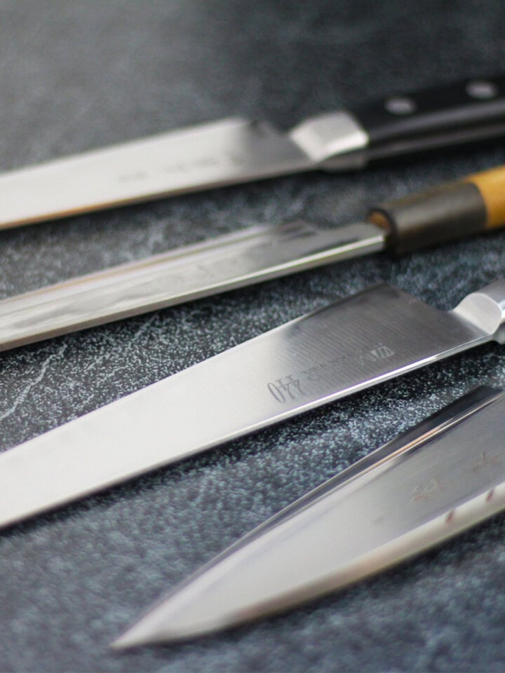 Different types of sushi knives including yanagiba, gyuto, sujihiki, deba
