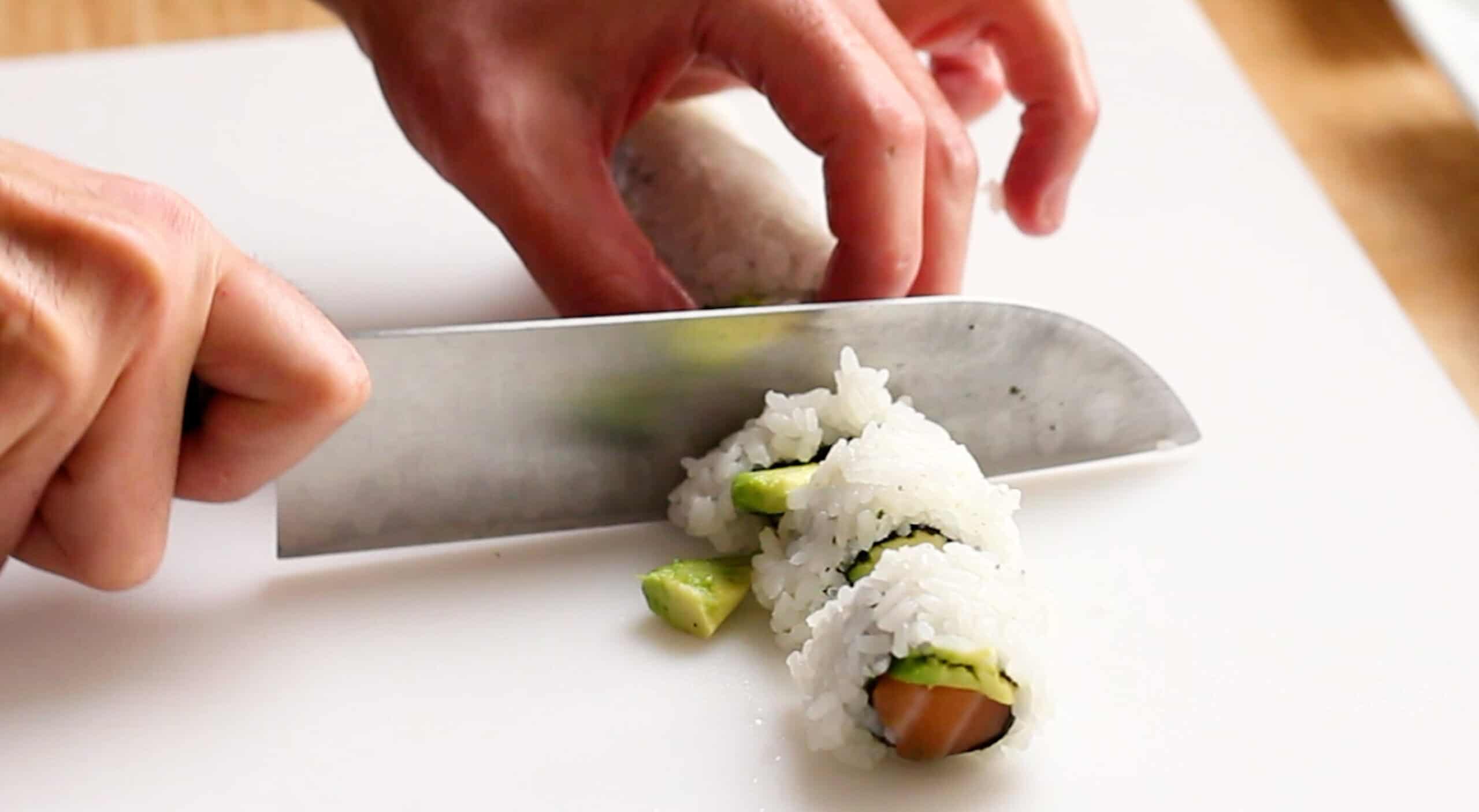 Dull knife trying to cut sushi roll