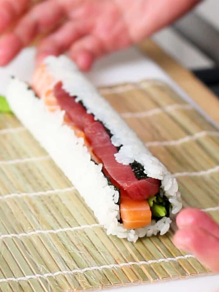 Overstuffed sushi roll with fillings falling out