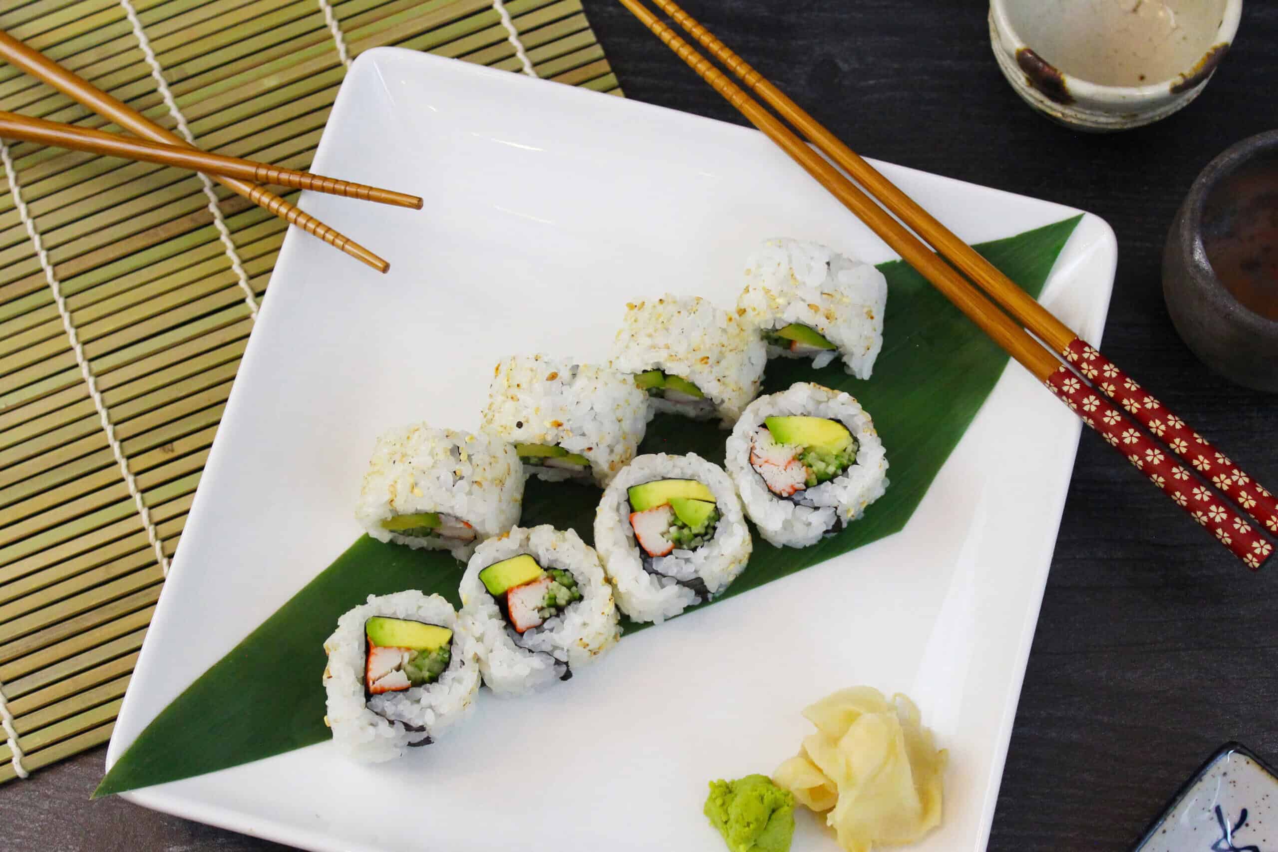 California roll sushi with sake and chopsticks