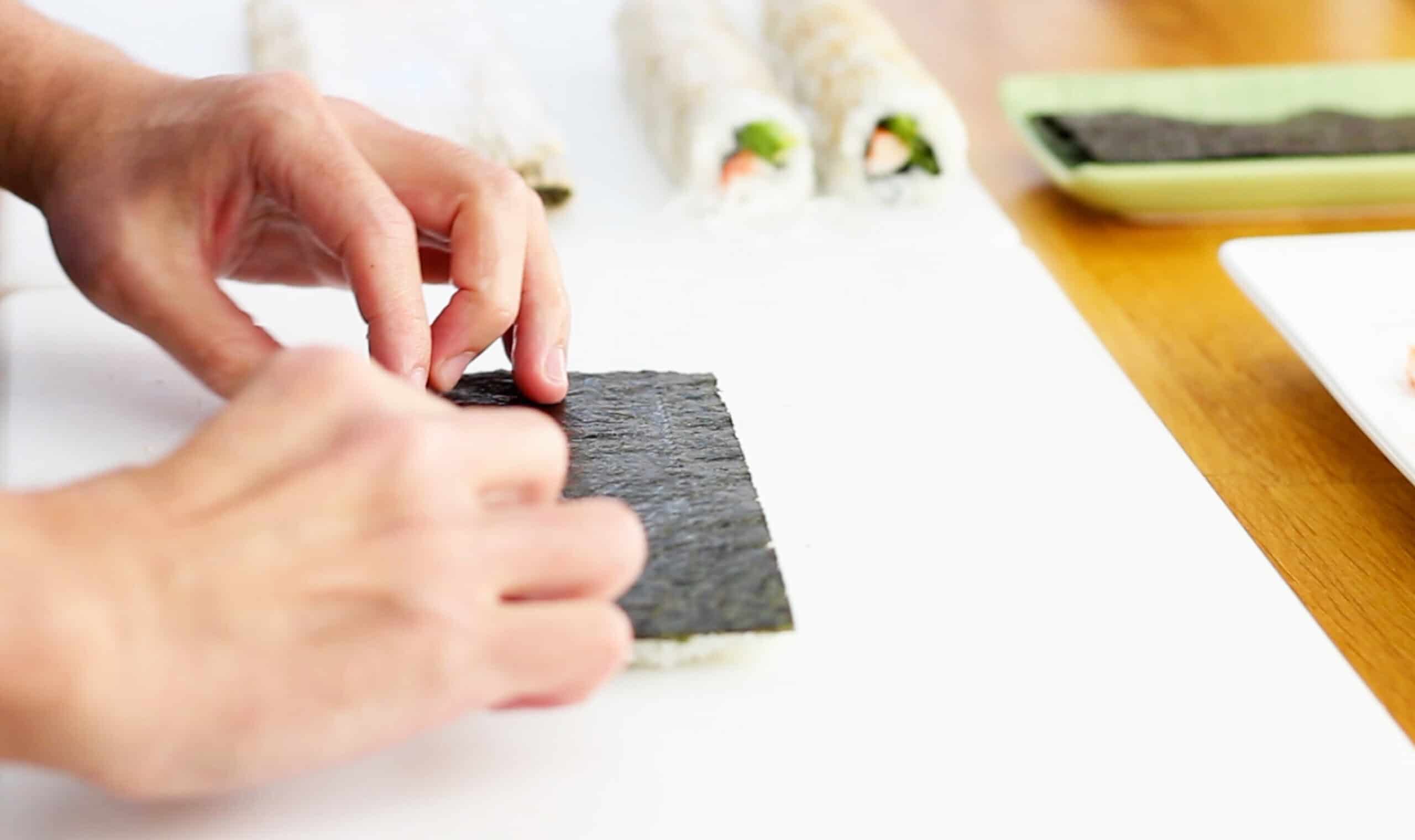Sheet of nori with sushi rice flipped over
