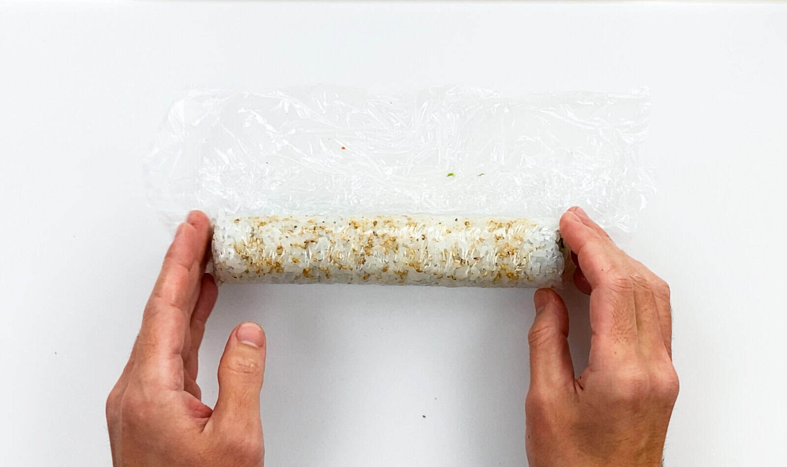Sushi roll wrapped in plastic wrap