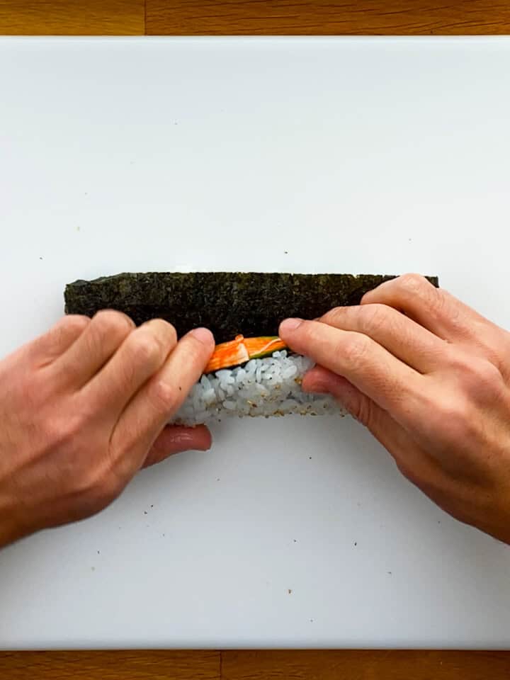 Close up of rolling sushi without a bamboo mat makisu