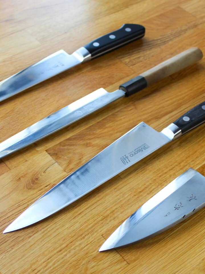 Four Japanese knives used for sushi: yanagiba, sujihiki, gyuto, and deba