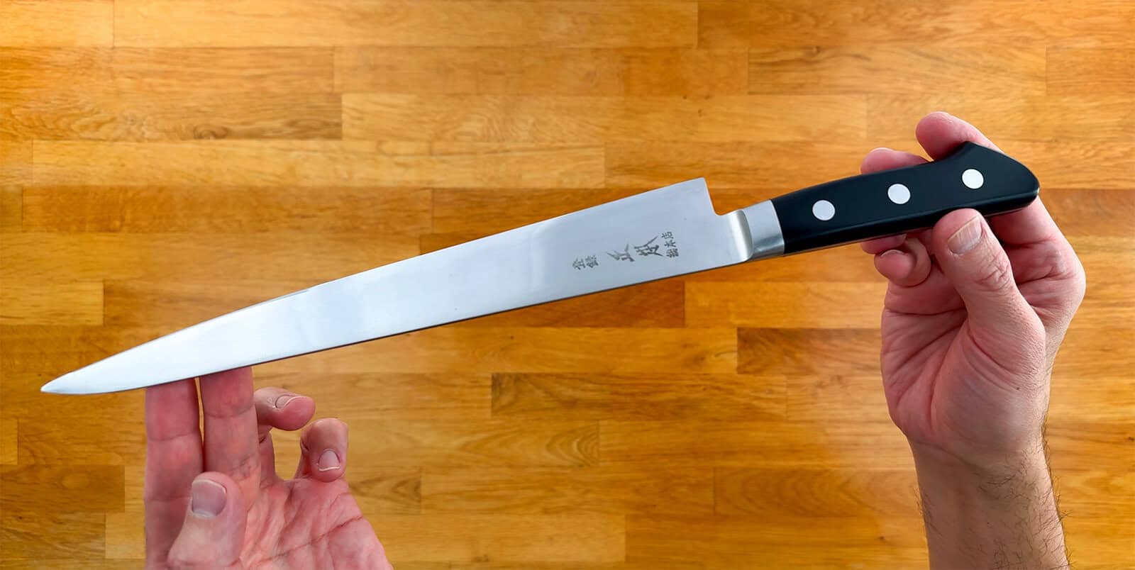 Masamoto VG 240 mm sujihiki knife held in hand