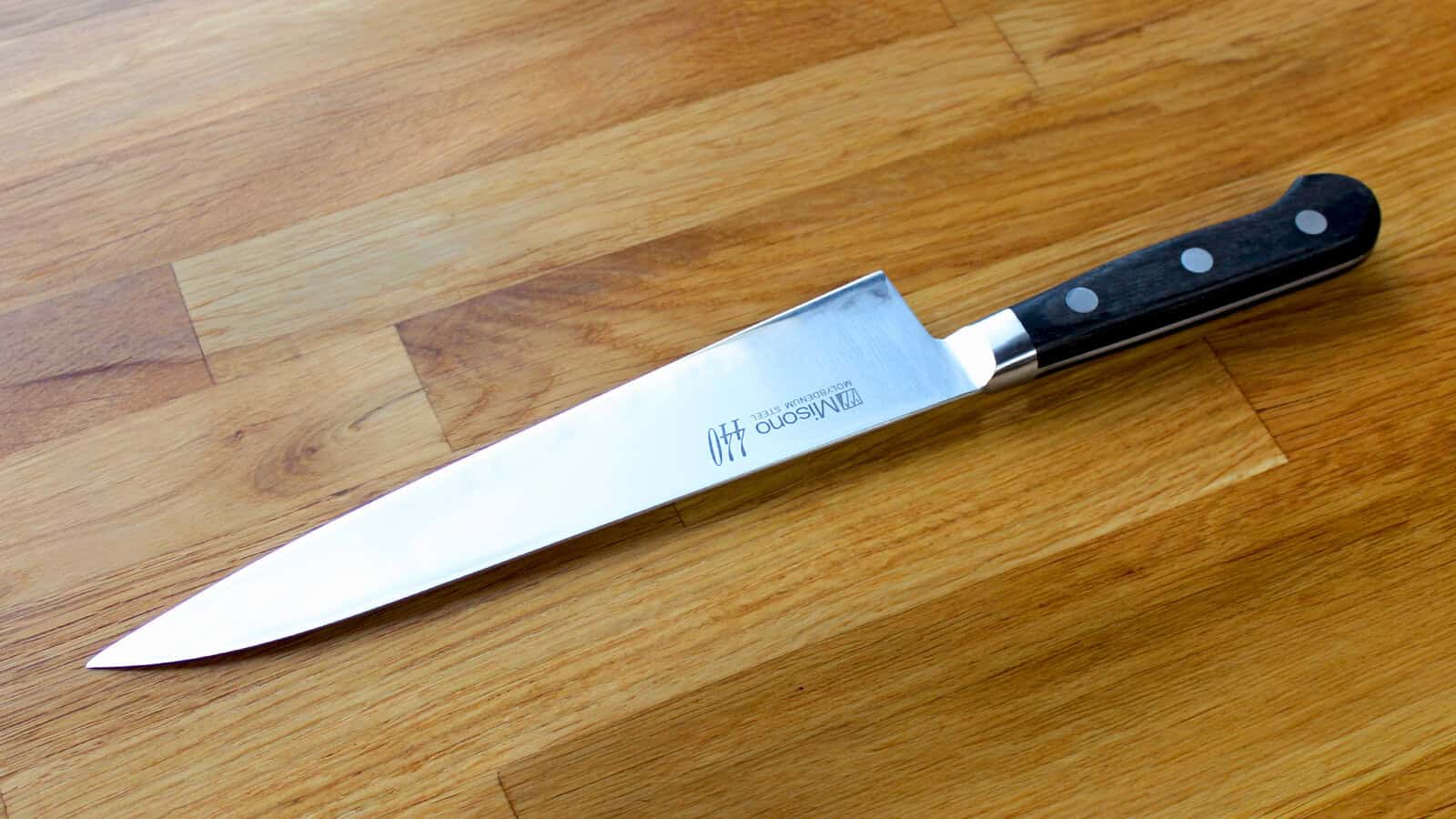 Misono 440 210 mm gyuto knife on a wooden surface