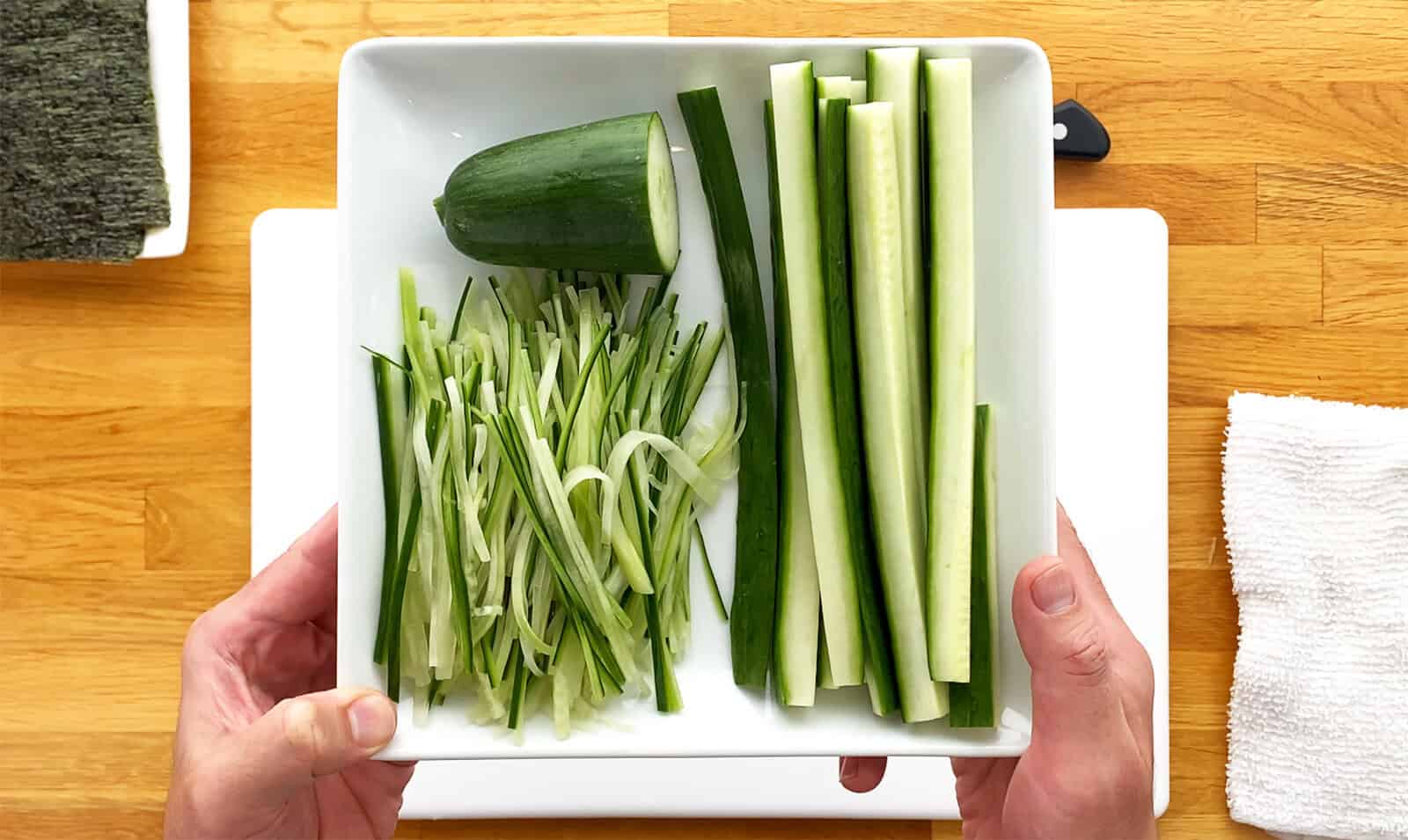 Thick cucumber sticks and thinly sliced cucumber prepared for sushi rolls